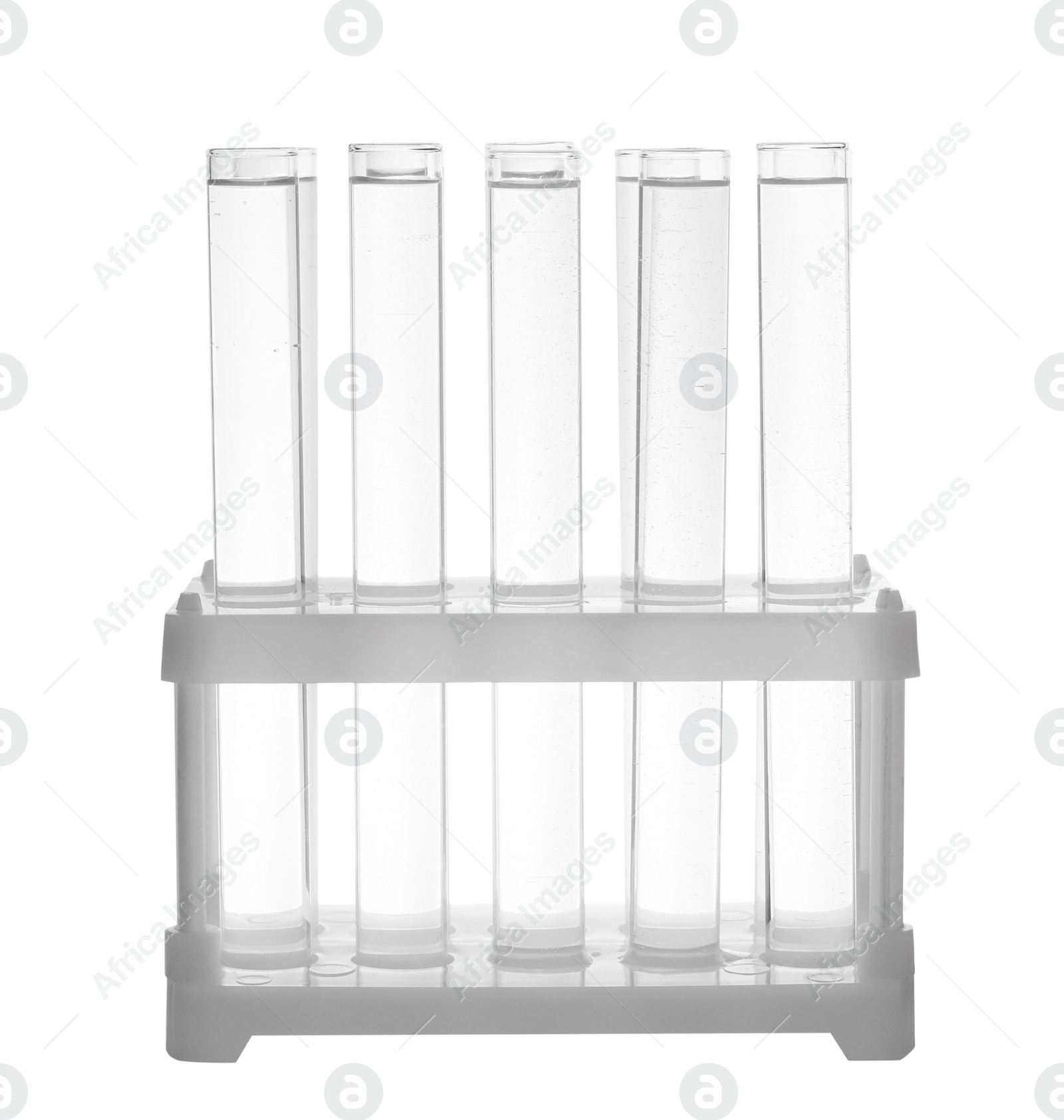 Photo of Test tubes with transparent liquid in holder isolated on white