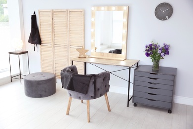 Photo of Hairdresser's workplace with comfortable chair and mirror in salon