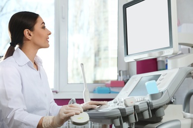 Sonographer using modern ultrasound machine in clinic