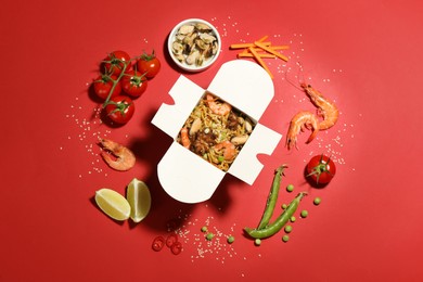 Photo of Flat lay composition with noodle wok and ingredients on red background