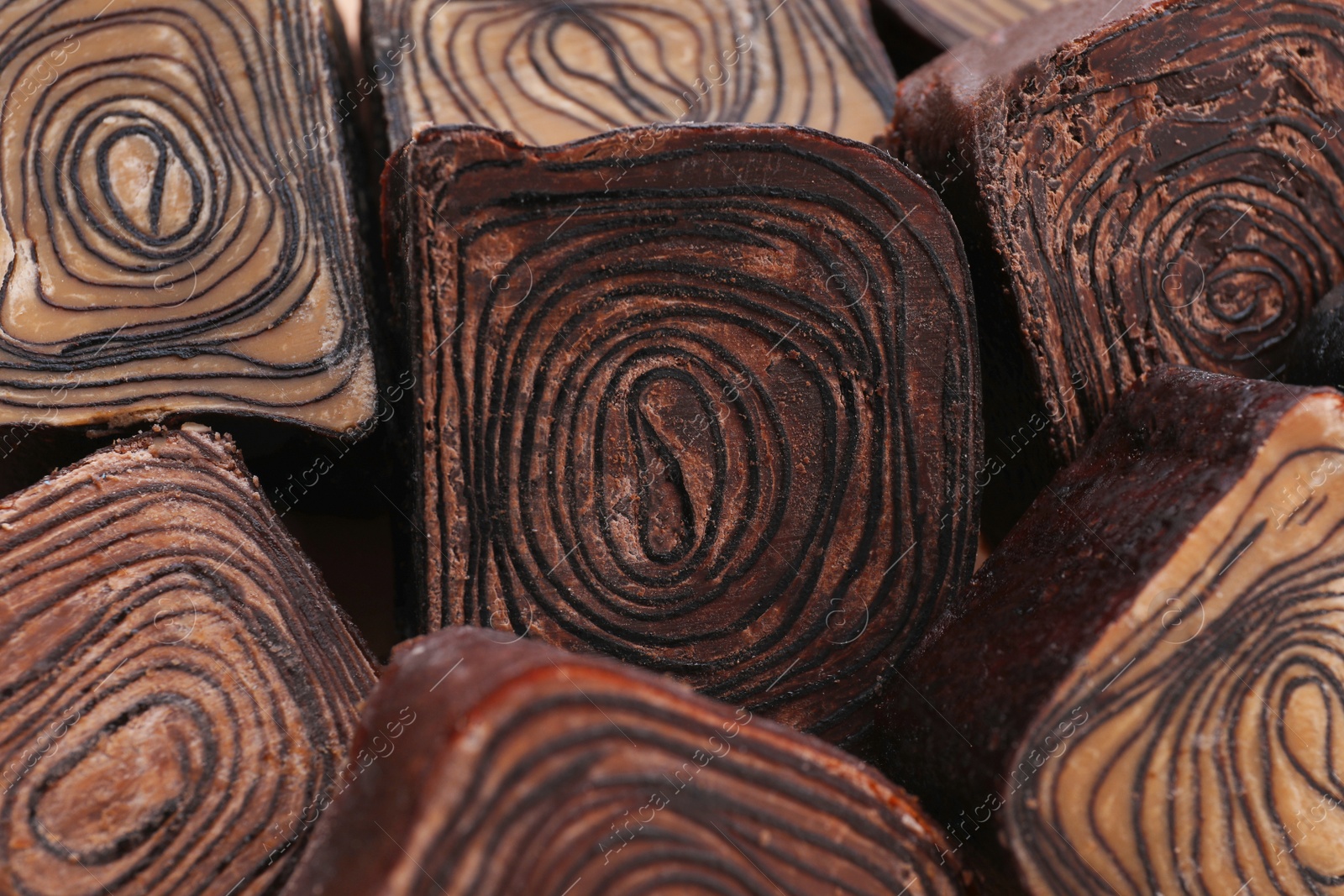 Photo of Different tasty chocolate candies as background, closeup