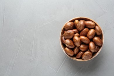 Bowl of jackfruit seeds on light table, top view. Space for text