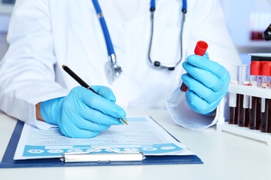 Photo of Scientist working at table in laboratory, closeup. Research and analysis