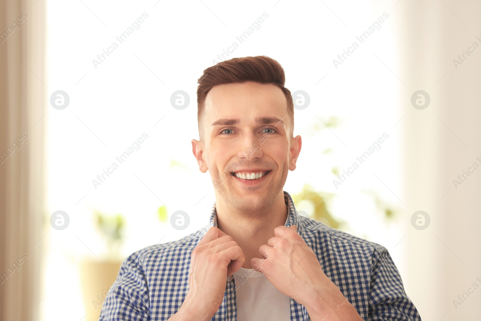 Photo of Portrait of young man with beautiful hair indoors