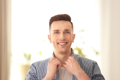 Portrait of young man with beautiful hair indoors