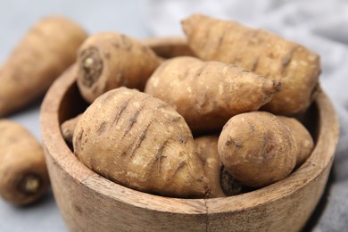 Photo of Tubers of turnip rooted chervil in bowl on table, closeup