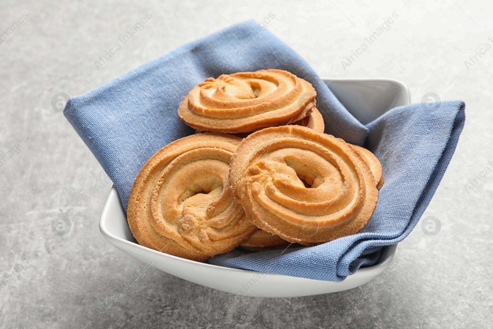 Photo of Bowl with Danish butter cookies on grey table