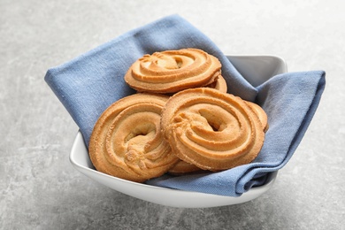 Photo of Bowl with Danish butter cookies on grey table