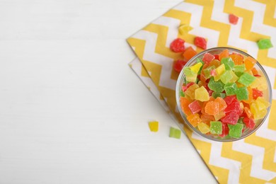 Photo of Mix of delicious candied fruits on white table, flat lay. Space for text