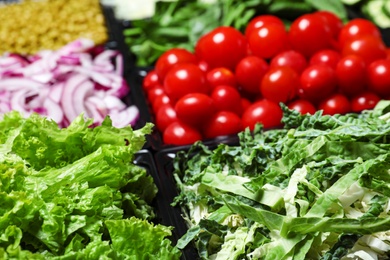 Photo of Salad bar with different fresh ingredients as background, closeup