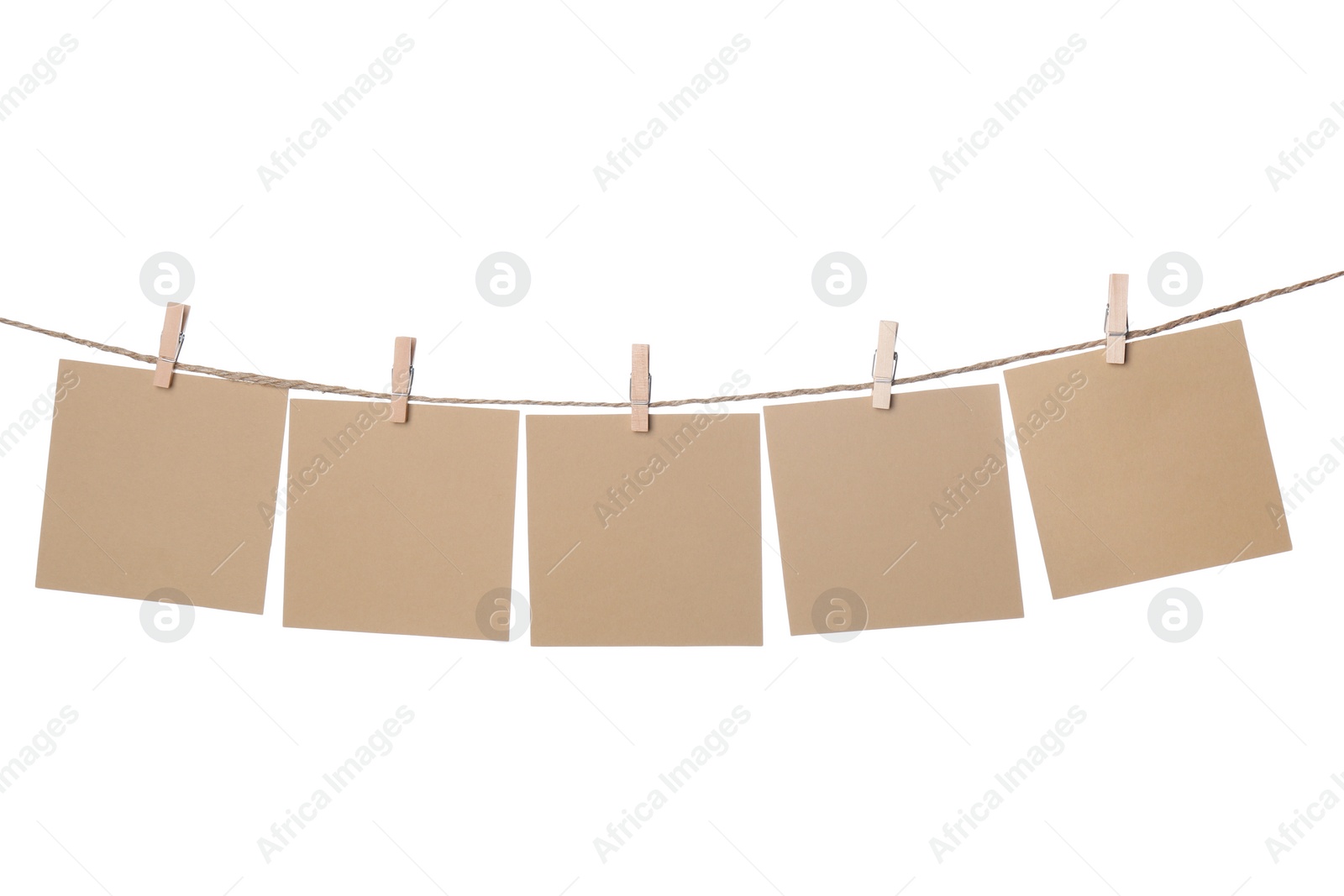 Photo of Clothespins with empty notepapers on string against white background. Space for text