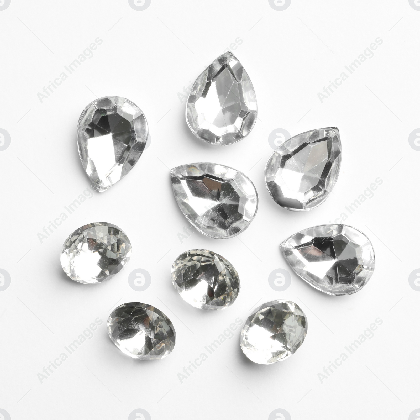 Image of Different beautiful gemstones on white background, top view