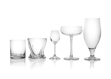 Photo of Set of empty glasses for different drinks on white background