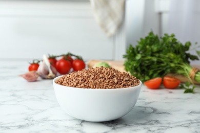 Photo of Buckwheat grains on white marble table indoors