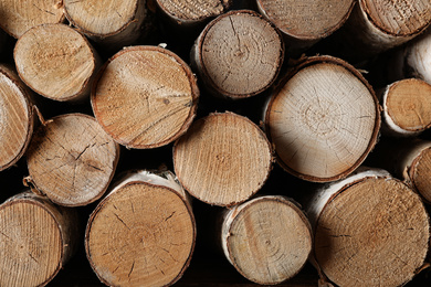 Photo of Cut firewood as background, closeup. Heating in winter