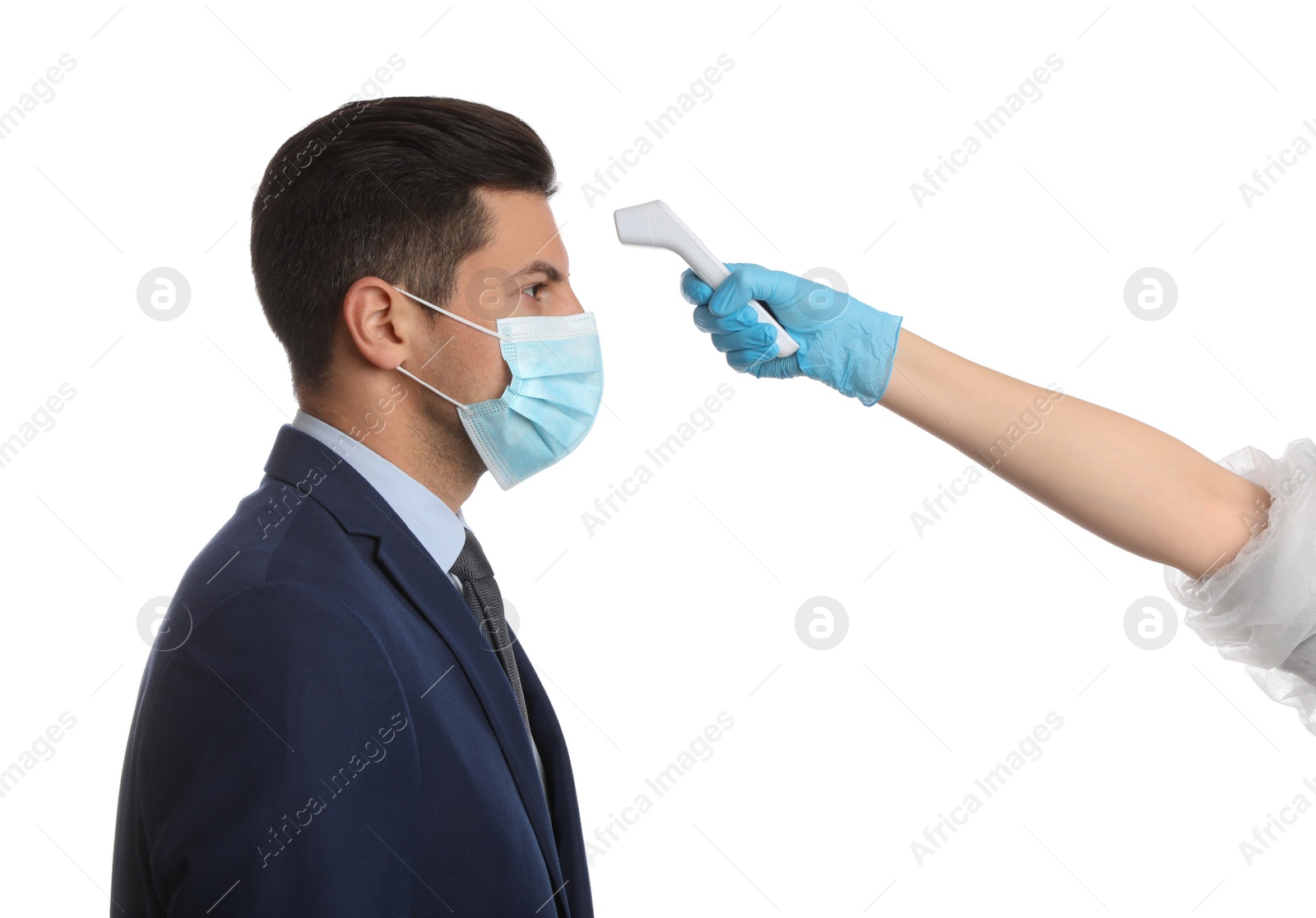 Photo of Doctor measuring man's temperature on white background, closeup. Prevent spreading of Covid-19