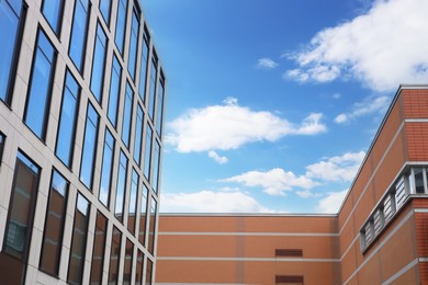 Photo of Modern buildings against blue sky, low angle view. space for text