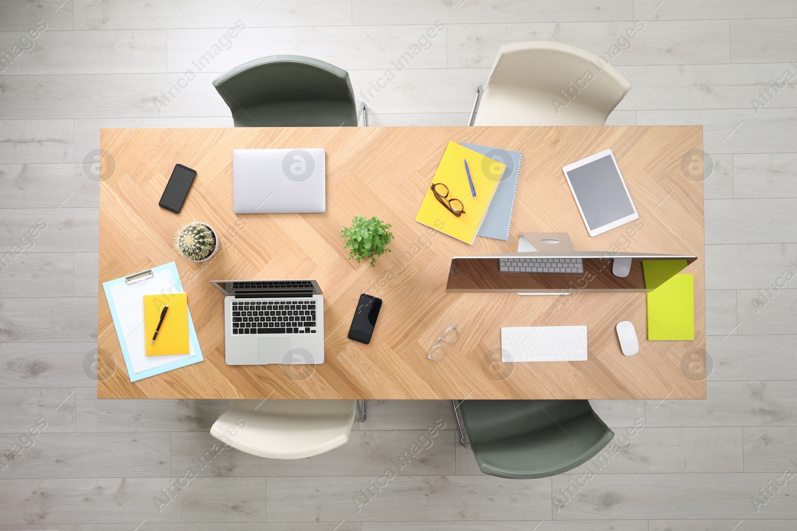 Photo of Modern office table with devices and chairs, top view