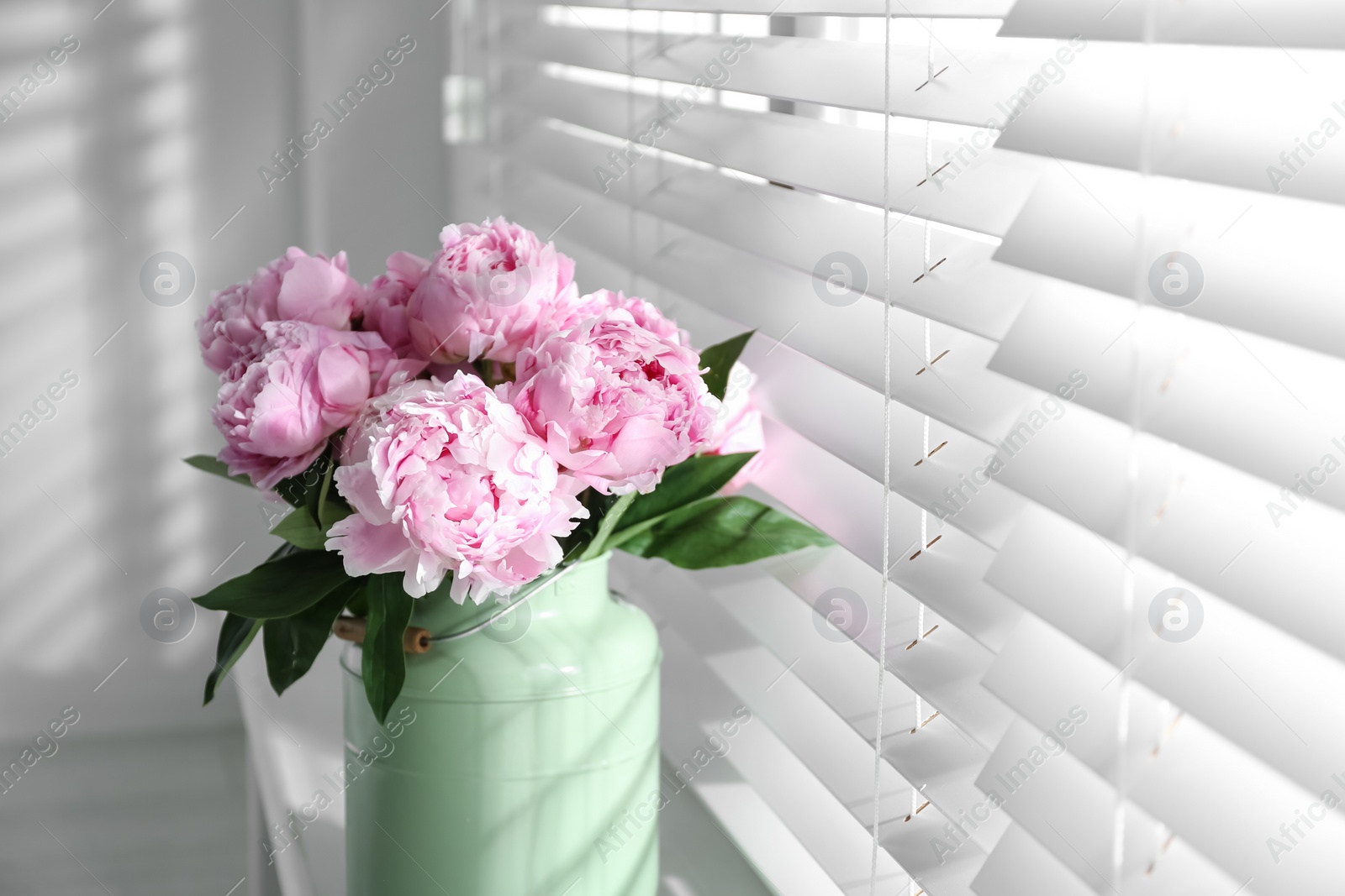 Photo of Bouquet of beautiful pink peonies near window. Space for text