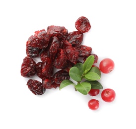 Photo of Tasty fresh and dried cranberries with leaves on white background, top view