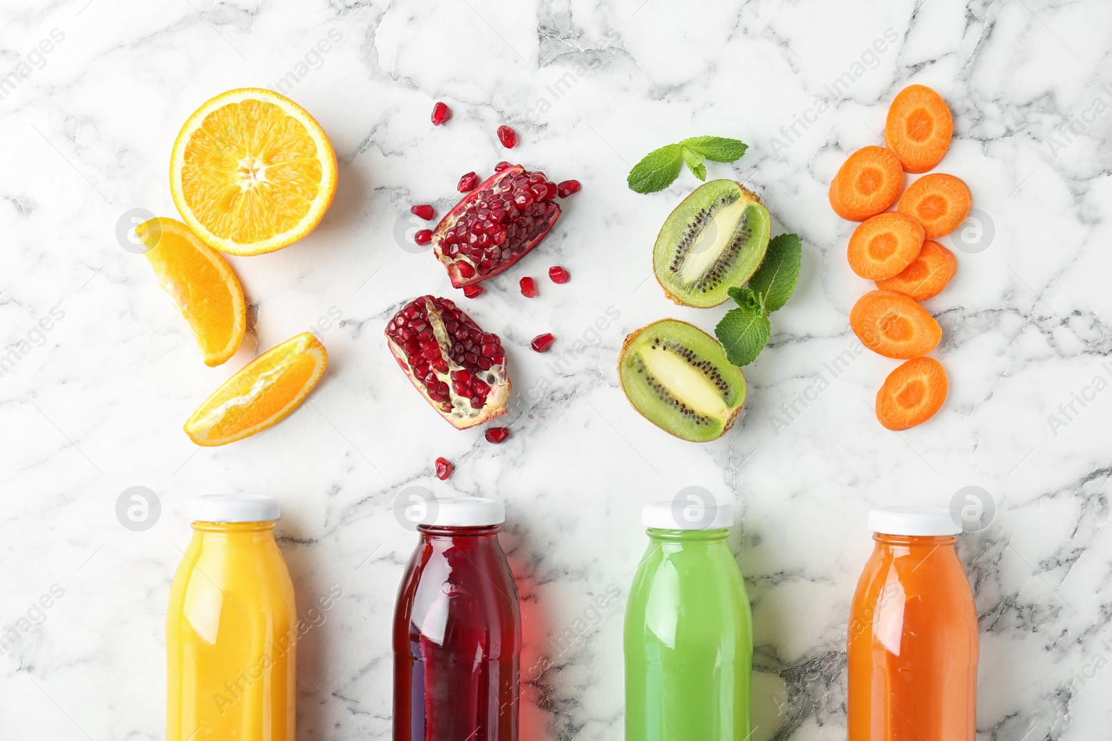 Photo of Flat lay composition with tasty juices and ingredients on marble background