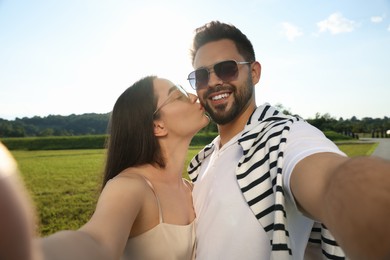 Photo of Romantic date. Beautiful couple making selfie outdoors