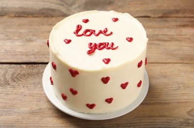 Photo of Bento cake with text Love You on wooden table. St. Valentine's day surprise