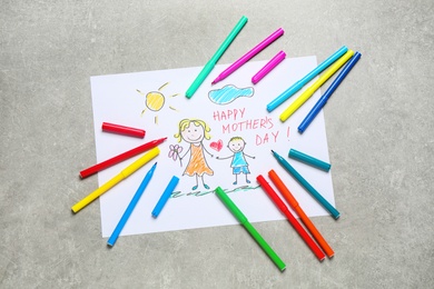 Photo of Handmade greeting card for Mother's Day and felt tip pens on grey table, flat lay