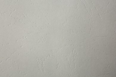 Photo of Texture of light grey paper sheet as background, closeup