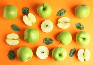 Photo of Flat lay composition of fresh ripe green apples on orange background