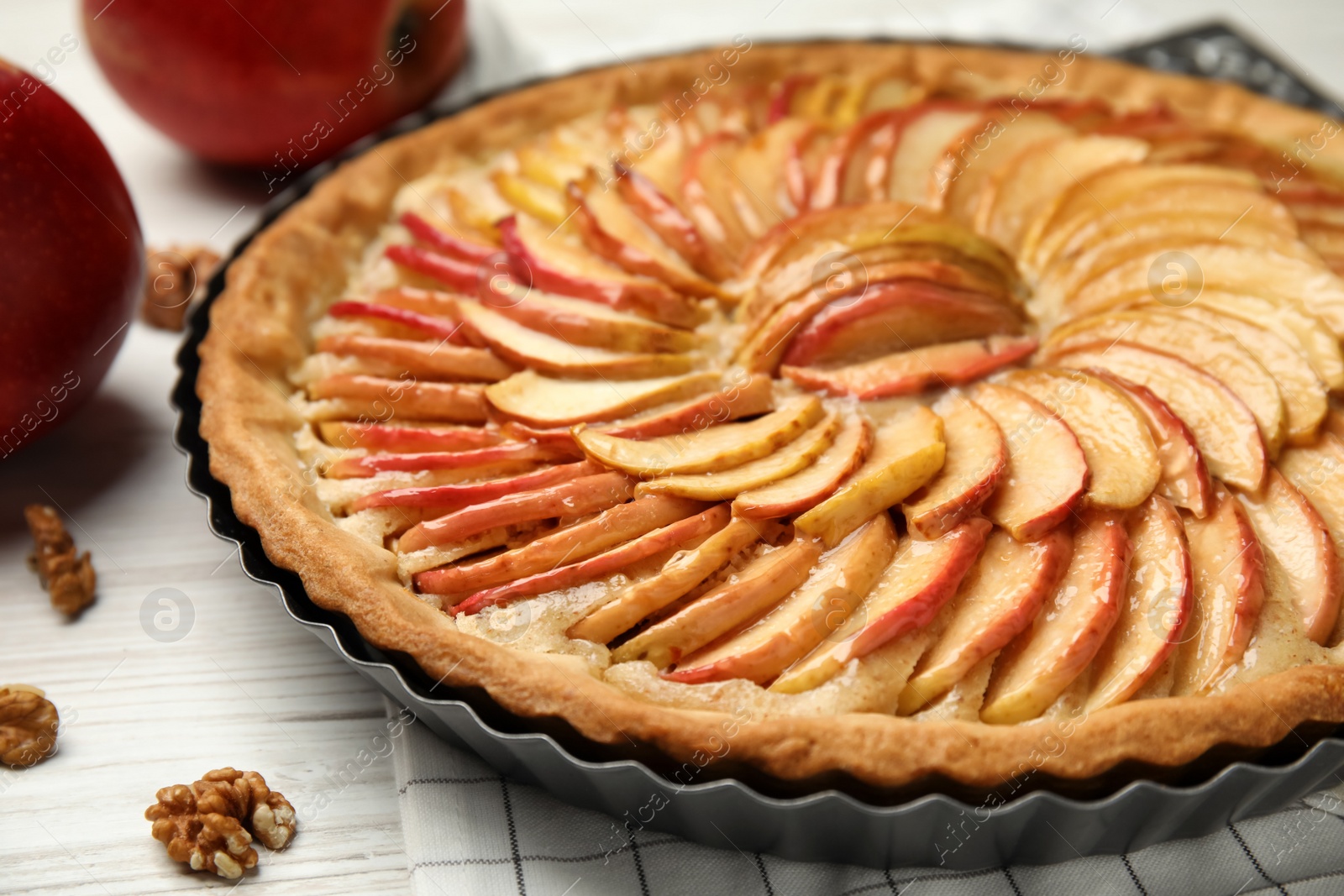 Photo of Delicious homemade apple tart on white wooden table, closeup