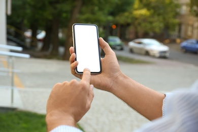 Man using modern mobile phone outdoors, closeup