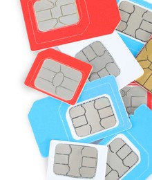 Pile of different SIM cards on white background, top view