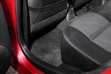 Photo of Black rubber car floor mat in auto