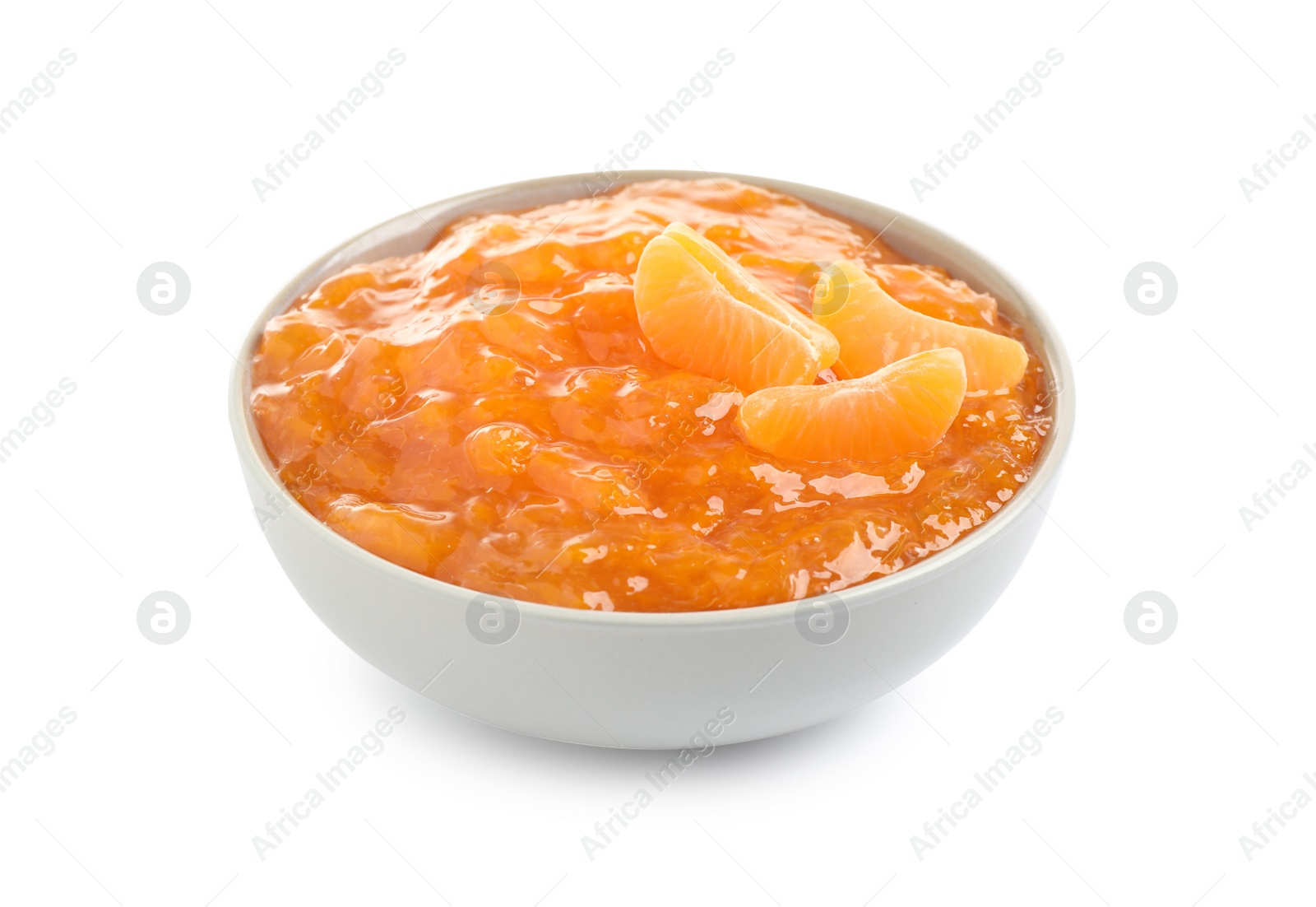 Photo of Tasty tangerine jam in ceramic bowl isolated on white