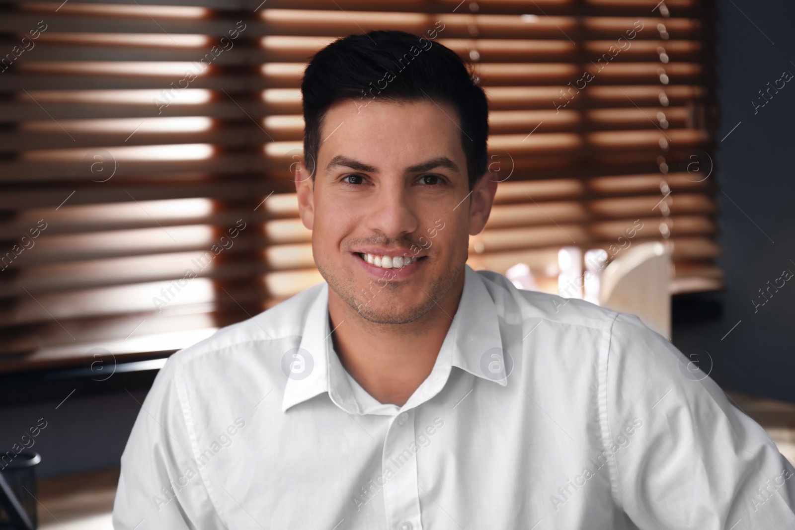 Photo of Man talking to his coworkers through video conference indoors, view from webcam