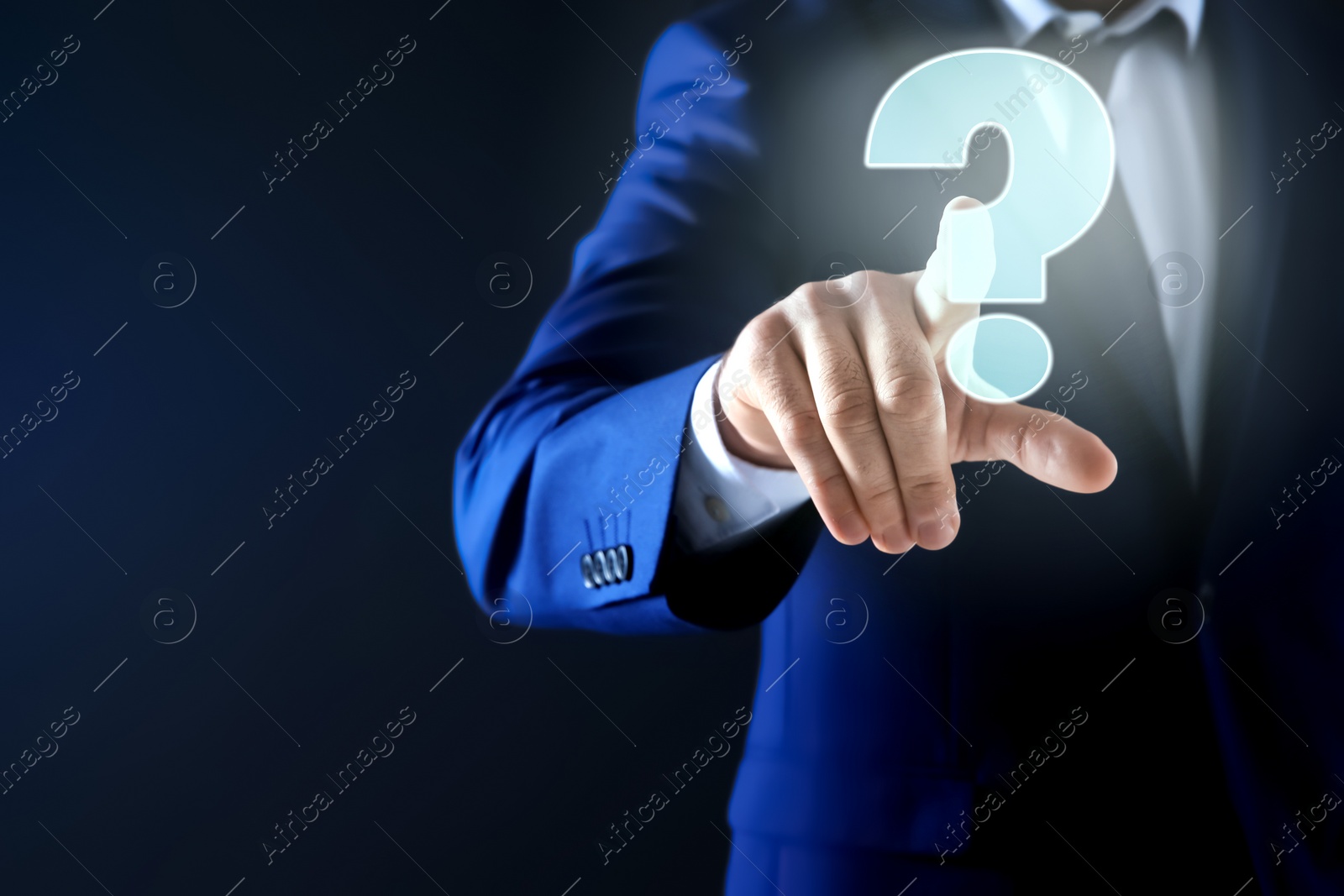 Image of Businessman using virtual screen with question mark symbol on dark background, closeup