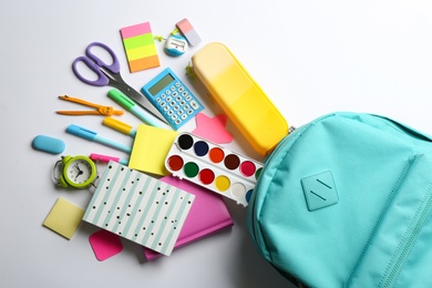 Photo of Backpack and school stationery on white background, flat lay. Back to school