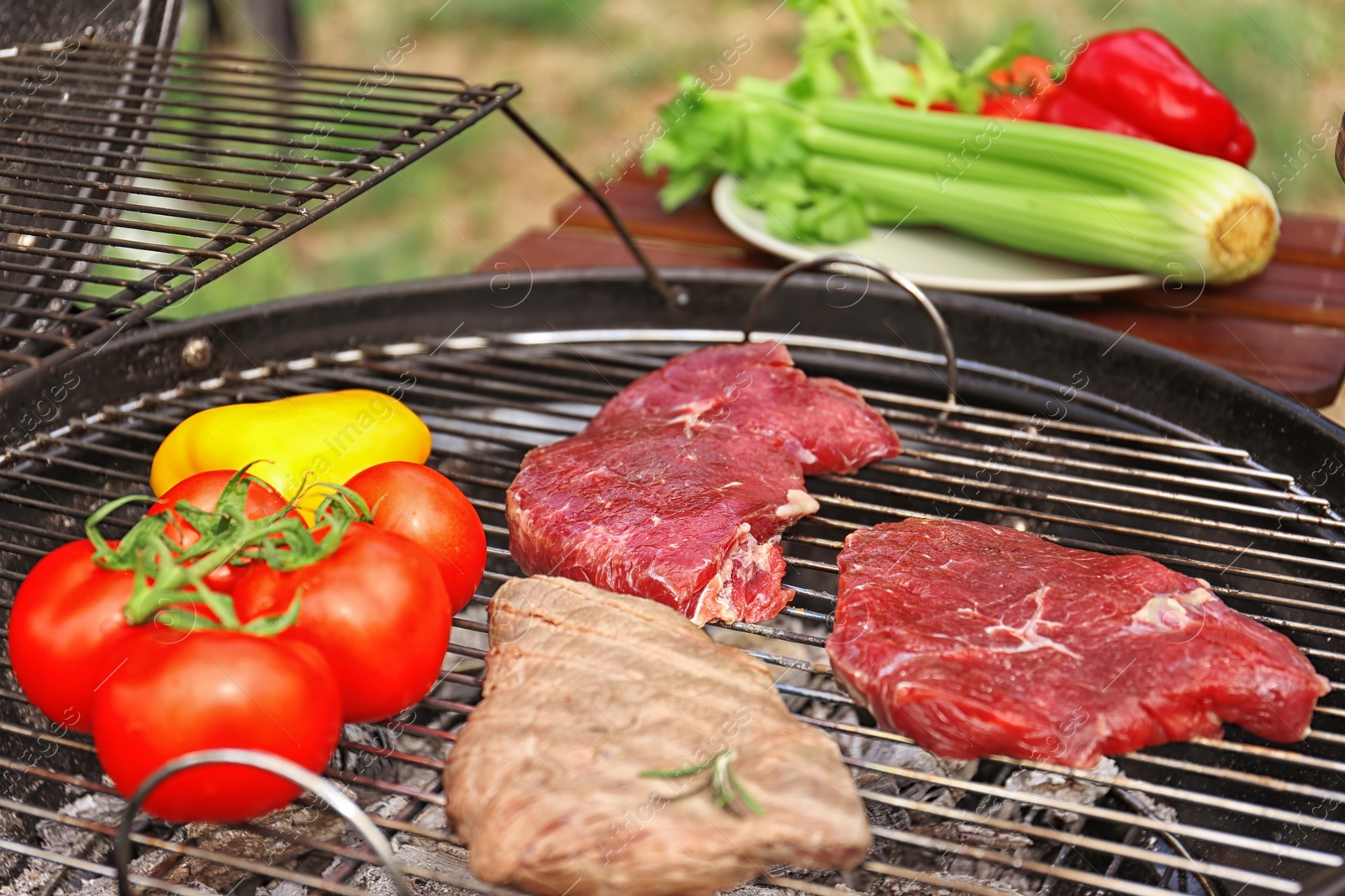 Photo of Modern grill with meat and vegetables outdoors, closeup