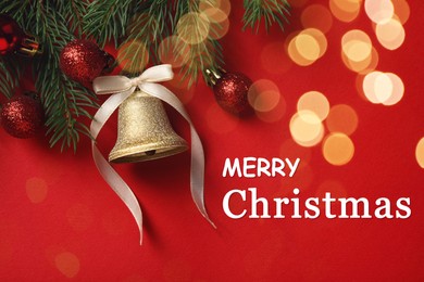 Image of Greeting card with phrase Merry Christmas. Fir tree branches with golden bell and festive balls on red background, flat lay. Bokeh effect