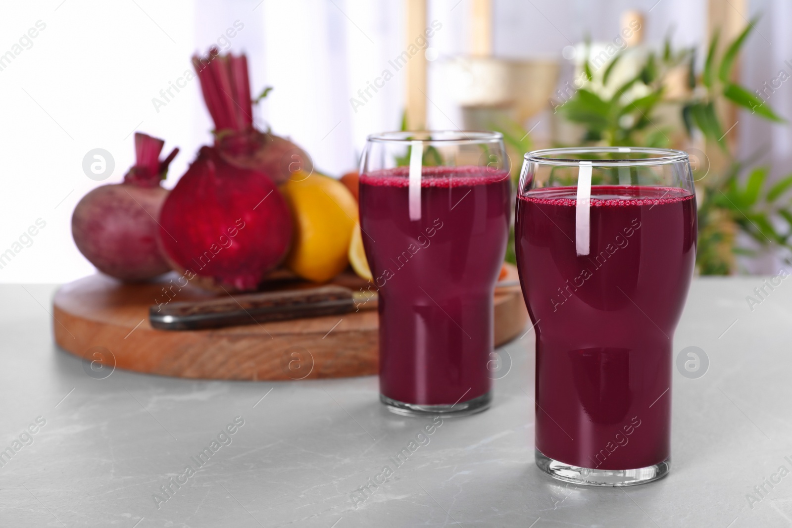 Photo of Glasses with fresh beet juice on table