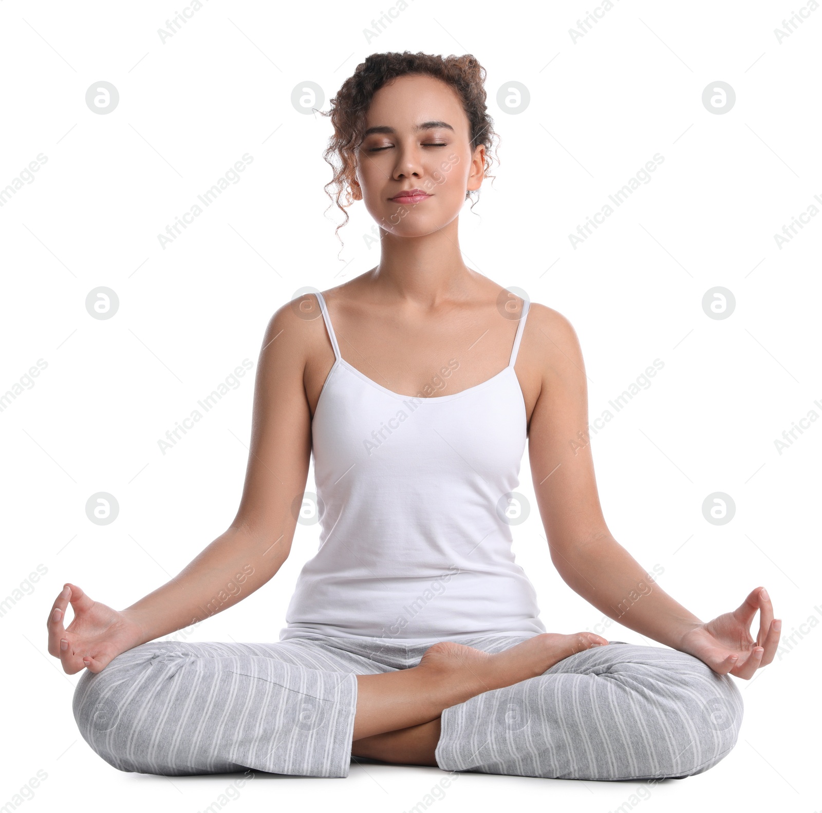 Photo of Beautiful African-American woman meditating on white background