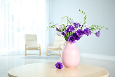 Photo of Vase with beautiful flowers on table indoors. Space for text