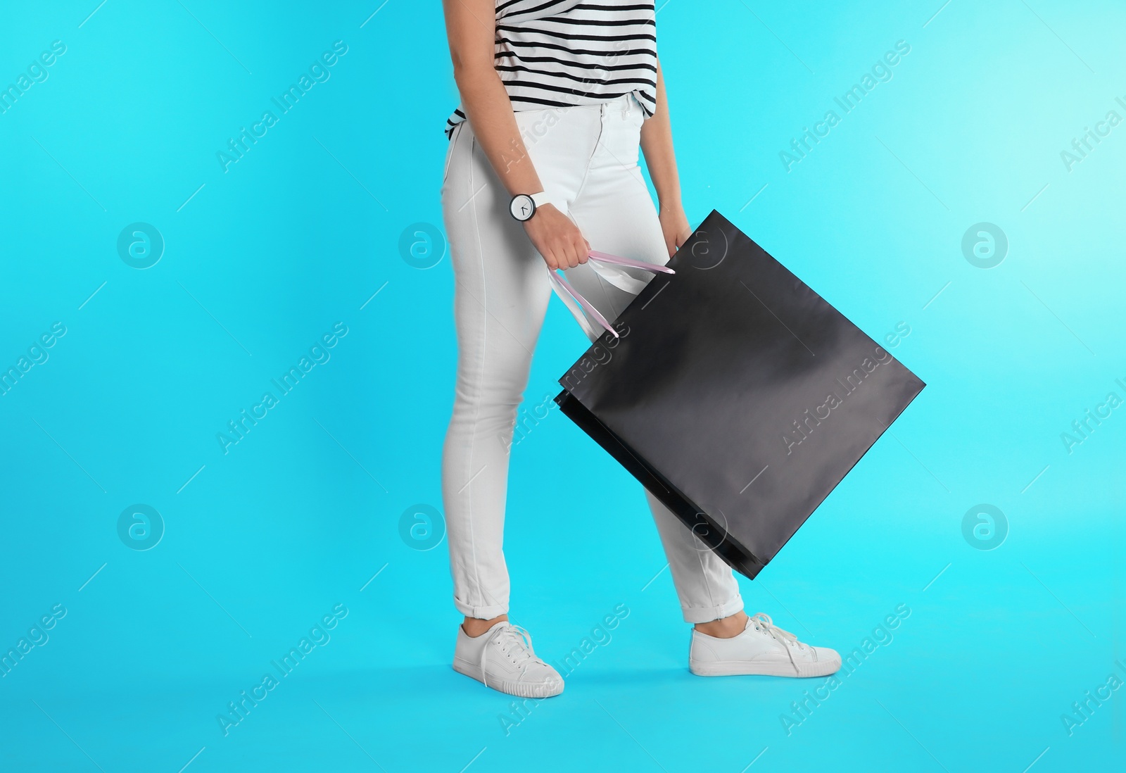 Photo of Woman with paper shopping bag on color background. Mock up for design