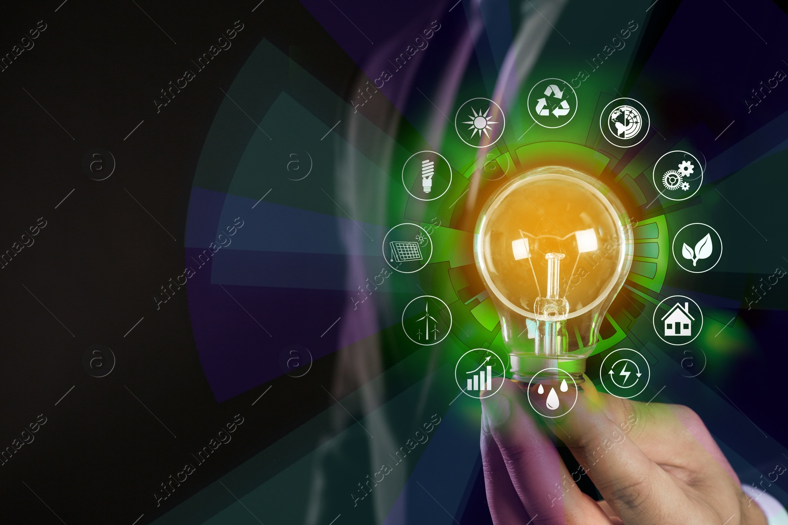 Image of Energy efficiency concept. Man holding light bulb surrounded by icons, closeup