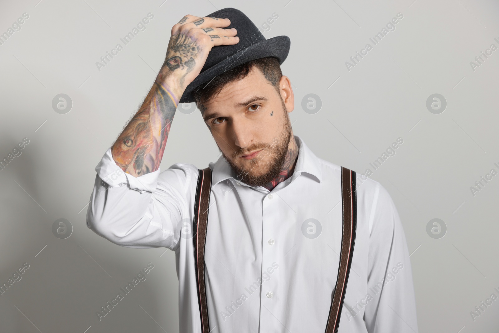 Photo of Portrait of hipster man on light grey background