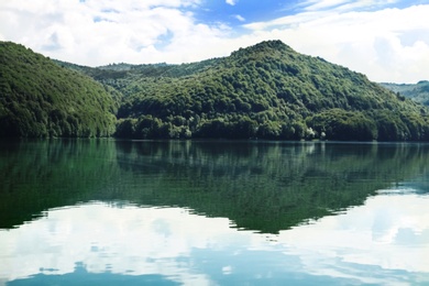 Picturesque view of beautiful lake surrounded by mountains on sunny day