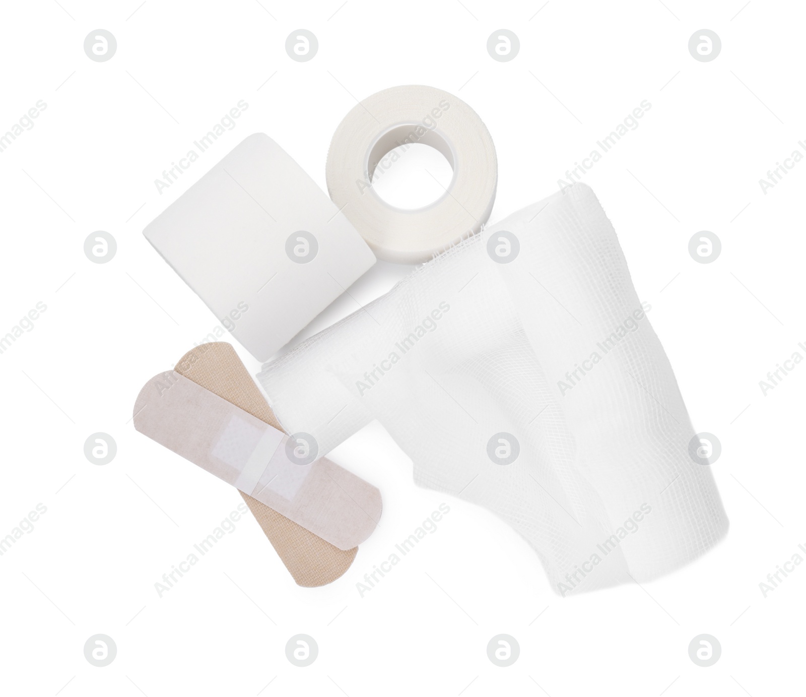 Photo of Bandage rolls and medical supplies on white background, top view