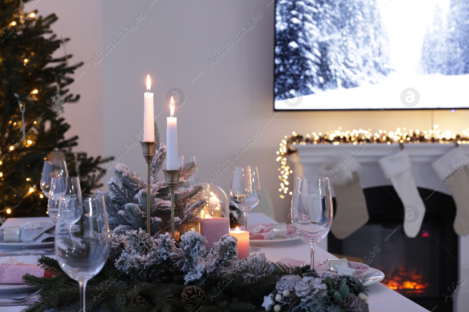 Photo of Beautiful festive table setting with Christmas decor in room