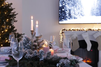 Beautiful festive table setting with Christmas decor in room